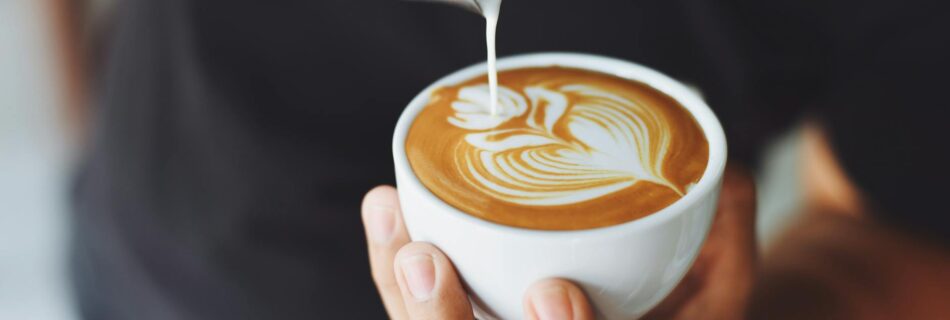 person performing coffee art